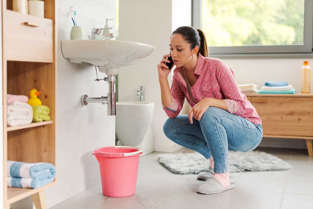 homeowner looking at a clogged sink